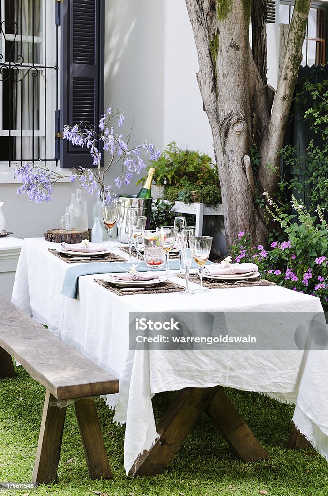 Garden party table setting Simple rustic country style table setting for a party gathering in a casual outdoor garden setting Outdoors Stock Photo