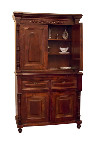 19th century wood sideboard with vintage objects in it isolated over white background