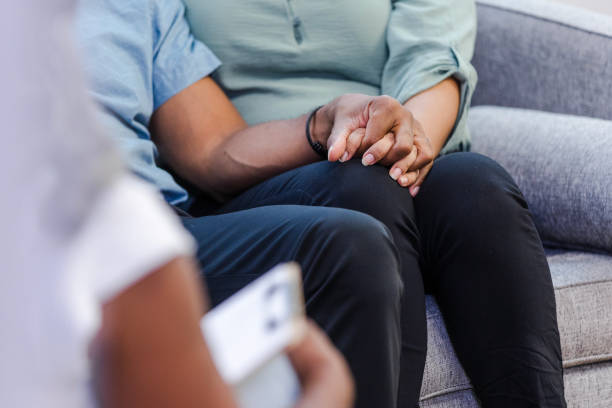 istock Unrecognizable diverse couple holds hands while listening to unrecognizable therapist 1786128692