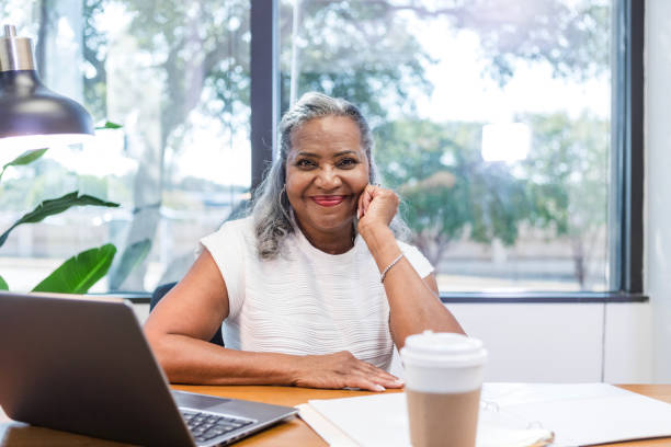 istock Successful senior female CEO sitting in office smiles for camera 1786129290