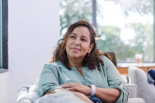 istock Stay-at-home mom takes break to sit on sofa and daydream 1786129294
