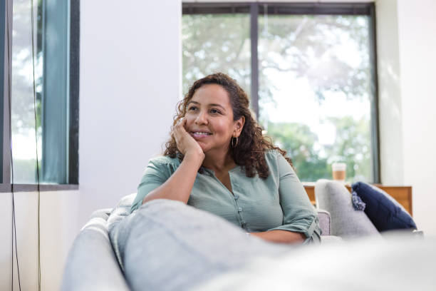 istock Content female freelancer takes break on sofa in living room 1786129307