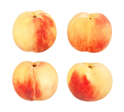 Fresh peaches with one cut in half - white background