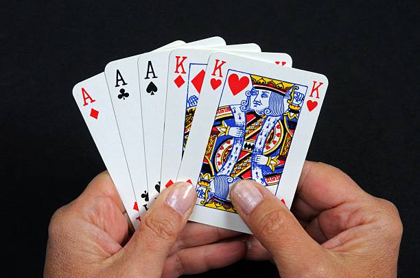 Full house poker hand. Full house poker hand against a black background. hand of cards stock pictures, royalty-free photos & images