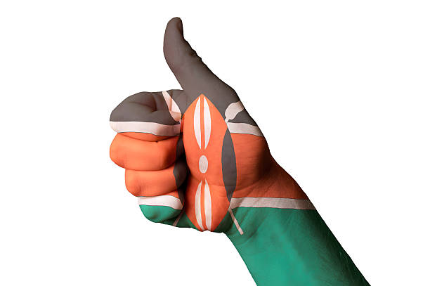 Hand with thumb up gesture in colored kenya national flag as symbol of excellence, achievement, good, - for tourism and touristic advertising, positive political, cultural, social management of country