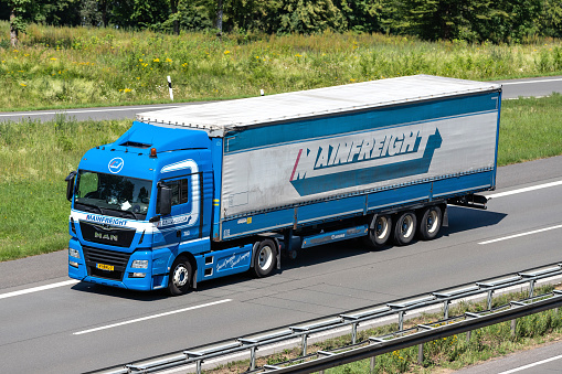 Engelskirchen, Germany - June 24, 2020: Mainfreight MAN truck with tarpaulin trailer on motorway