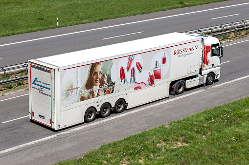 Engelskirchen, Germany - June 24, 2020: Blank MAN truck with Rossmann trailer on motorway