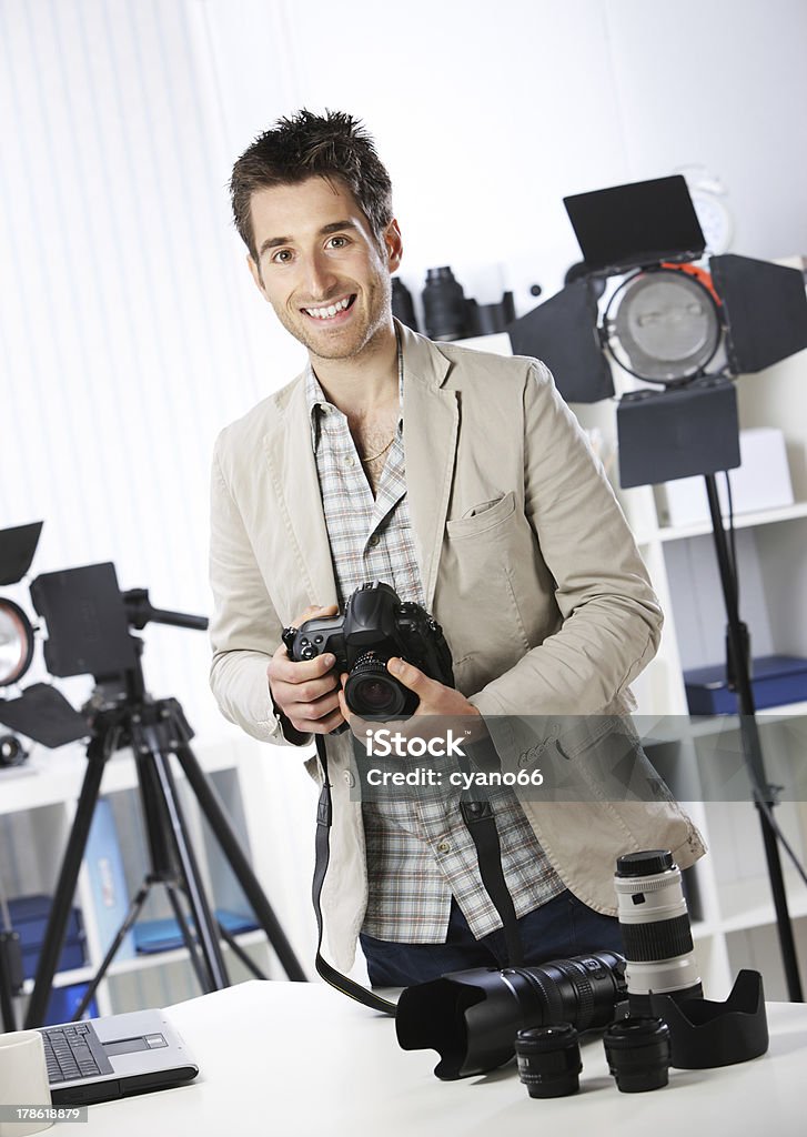 Photographer Portrait of young male photographer with professional digital camera Adult Stock Photo