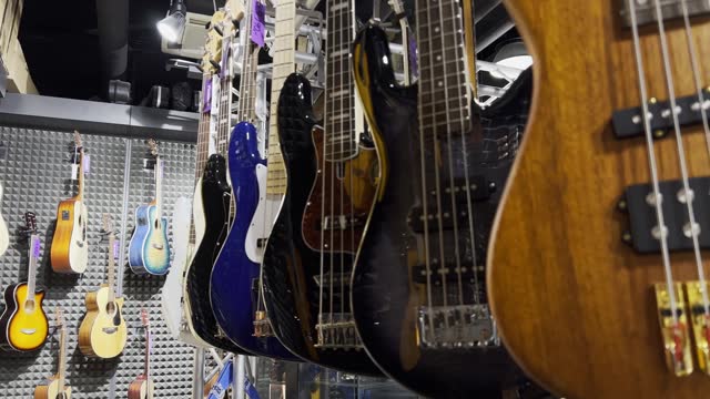 A store with musical instruments, classical and electric guitars