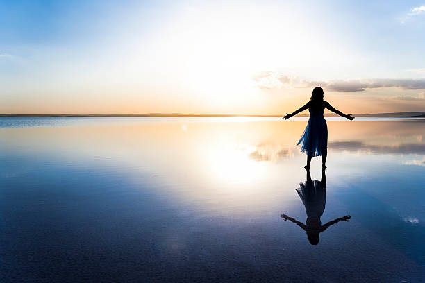 istock Woman on lake at sunset representing freedom 178619180