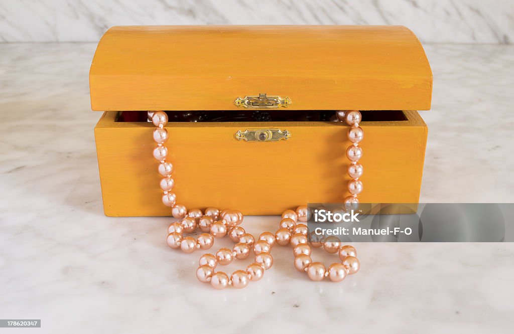 wooden coffer with pearls collar inside pearl necklace in an old box orange Hiding Stock Photo