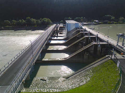 Hydroelectric Dam power plant or Hydro Power Station on a river, aerial drone view in sunset. Green energy.