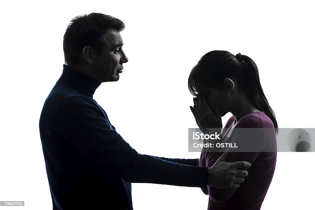 couple woman crying man consoling silhouette one caucasian couple woman crying man consoling in silhouette studio on white background Adult Stock Photo