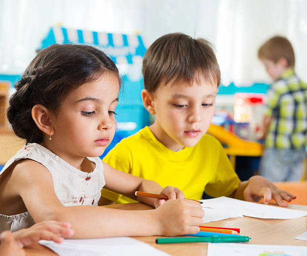 istock Cute preschoolers drawing with colorful pencils 178621868
