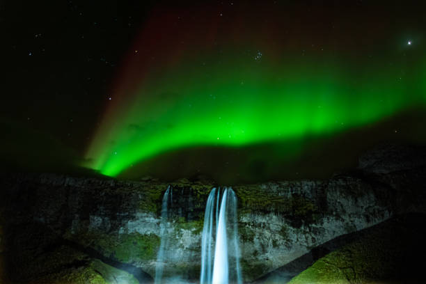 istock Northern lights above waterfall 1 1786227422