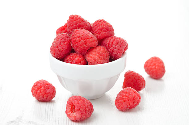 istock fresh raspberries in a white bowl 178623173