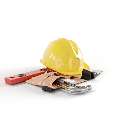 An orange hard hat, wrenches, and medical supplies on a white background are viewed in this image