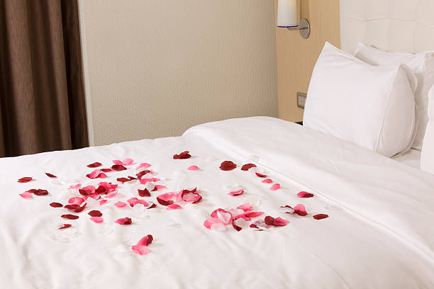 istock hotel room with big bed and red flowers 178623868