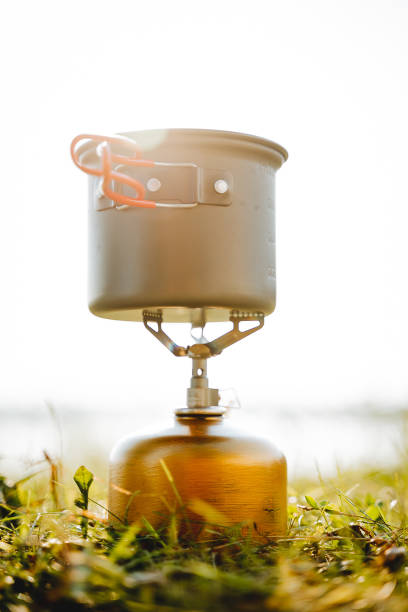 istock Gas heating pad for cooking on a camping trip, a pan for cooking, climber's equipment, sunlight, tourist dishes against the background of the sunset. 1786239121