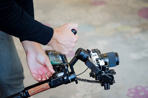 A cinematographer shoots a film on a camera using a camera stabilizer, steadicams for smooth movement of the picture in the frame, a technical device of the film industry. High quality photo