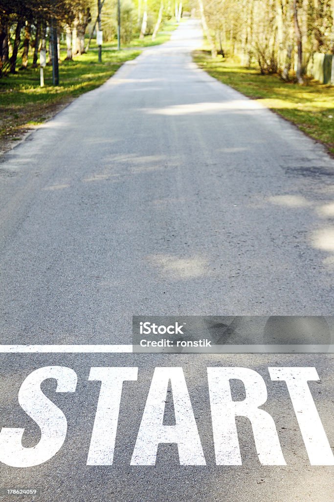 road with white start sign asphalt road with white start sign Asphalt Stock Photo