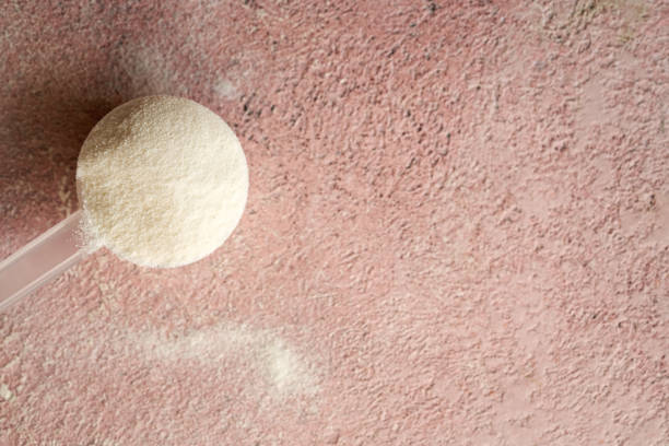 istock Collagen powder in a measuring spoon on pink background with copy space 1786244571