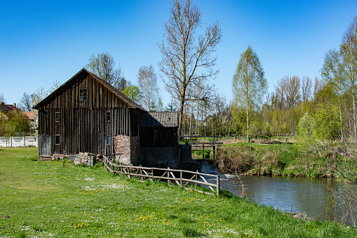 Wooden mill on the river in Poland, Summer