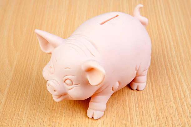 istock Piggy-bank on a wooden table 178626589