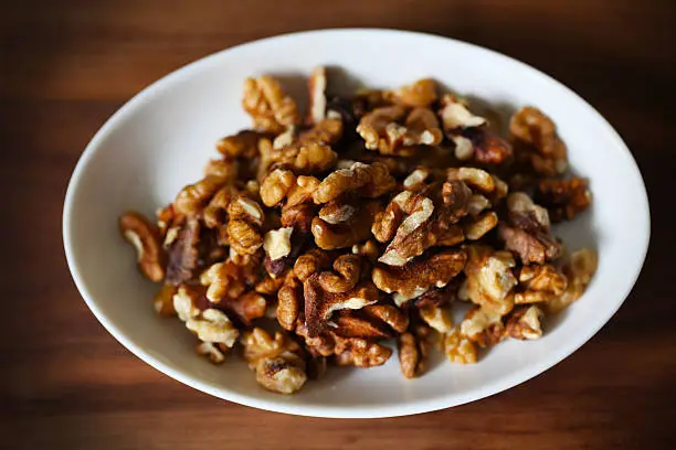 Photo of Walnuts, shelled on white plate