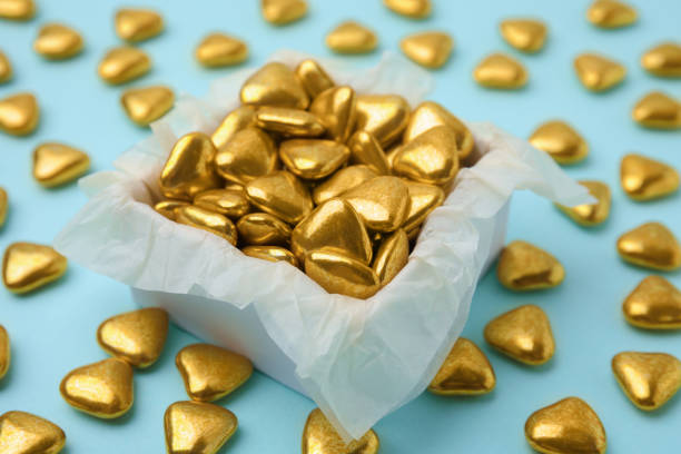 istock Box and delicious heart shaped candies on light blue background, closeup 1786278710