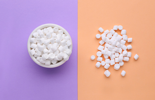 Delicious marshmallows on color background, flat lay