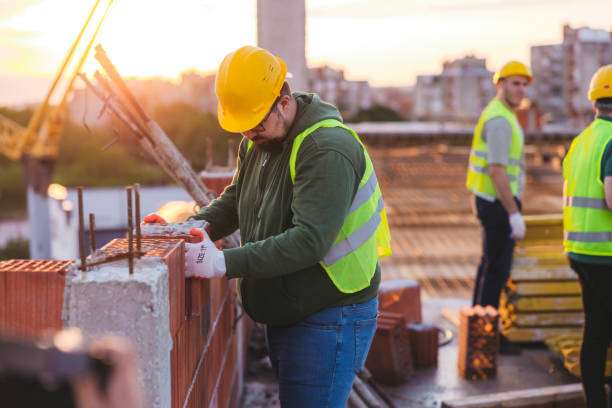 istock Young white construction worker working on the site by laying blocks 1786284195