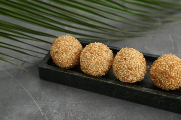 istock Delicious sesame balls and green leaf on grey table 1786287483
