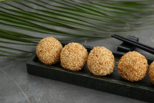 istock Delicious sesame balls and green leaf on grey table 1786287497