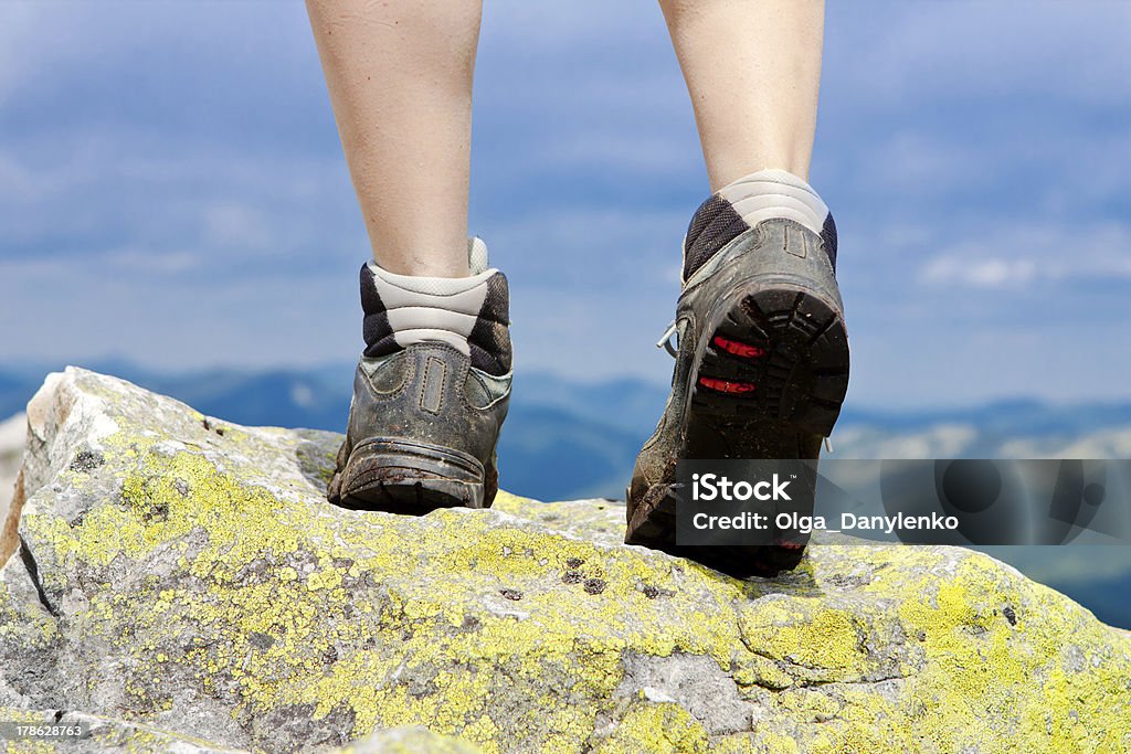 Hiking Boots and Legs of a Girl in the mountains Achievement Stock Photo