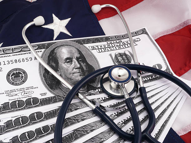 istock 100 Dollar Bills And Stethoscope Over American Flag 178628817