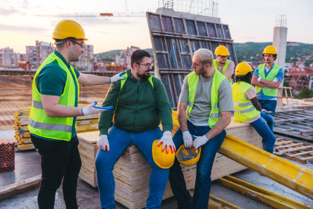 istock Male construction workers on a break on top of the building site roof 1786288606