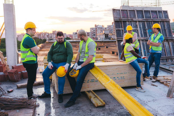 istock Male construction workers on a break on top of the building site roof 1786288610