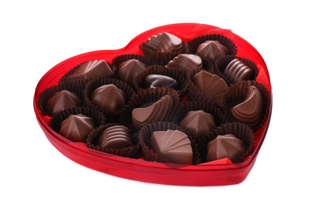 istock Heart shaped box with delicious chocolate candies on white background 1786288613