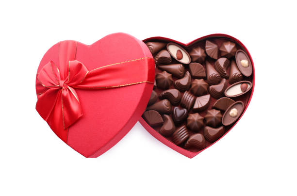 istock Heart shaped box with delicious chocolate candies on white background, top view 1786288621