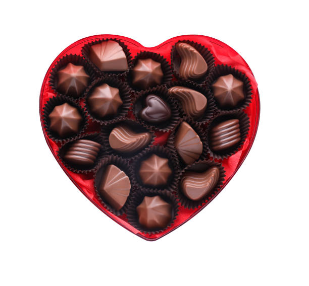 istock Heart shaped box with delicious chocolate candies on white background, top view 1786288626