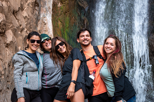 Group of friends on vacation. Group of friends at waterfall. Friend in the Devil's Throat, Jujuy, Argentina. Group of people on vacation in Argentina. Beautiful Argentine landscape