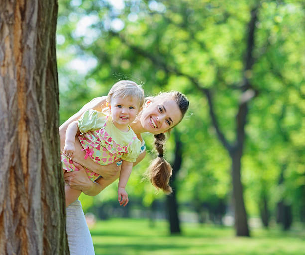 istock Happy mother and baby looking out from tree 178629599