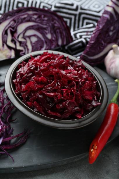 istock Tasty red cabbage sauerkraut and ingredients on grey table 1786297790