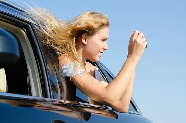 istock Woman in car taking photographs 178629781