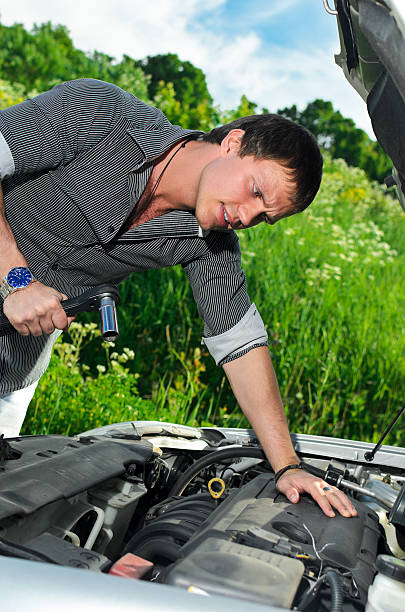 istock Young man repairing  broken car with a socket spanner wrench. 178629795