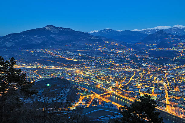 Overview of Trento in night time stock photo