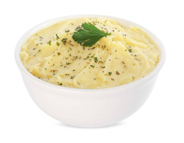 istock Bowl of delicious mashed potato with parsley isolated on white 1786309187