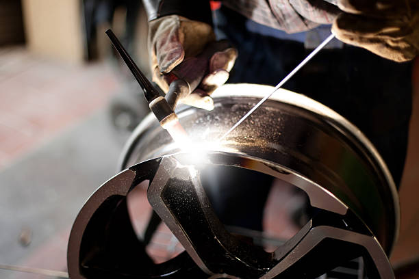 Alloy wheel repair. TIG welder stock photo
