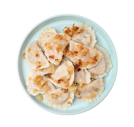 Cooked dumplings (varenyky) with tasty filling and fried onions on white background, top view